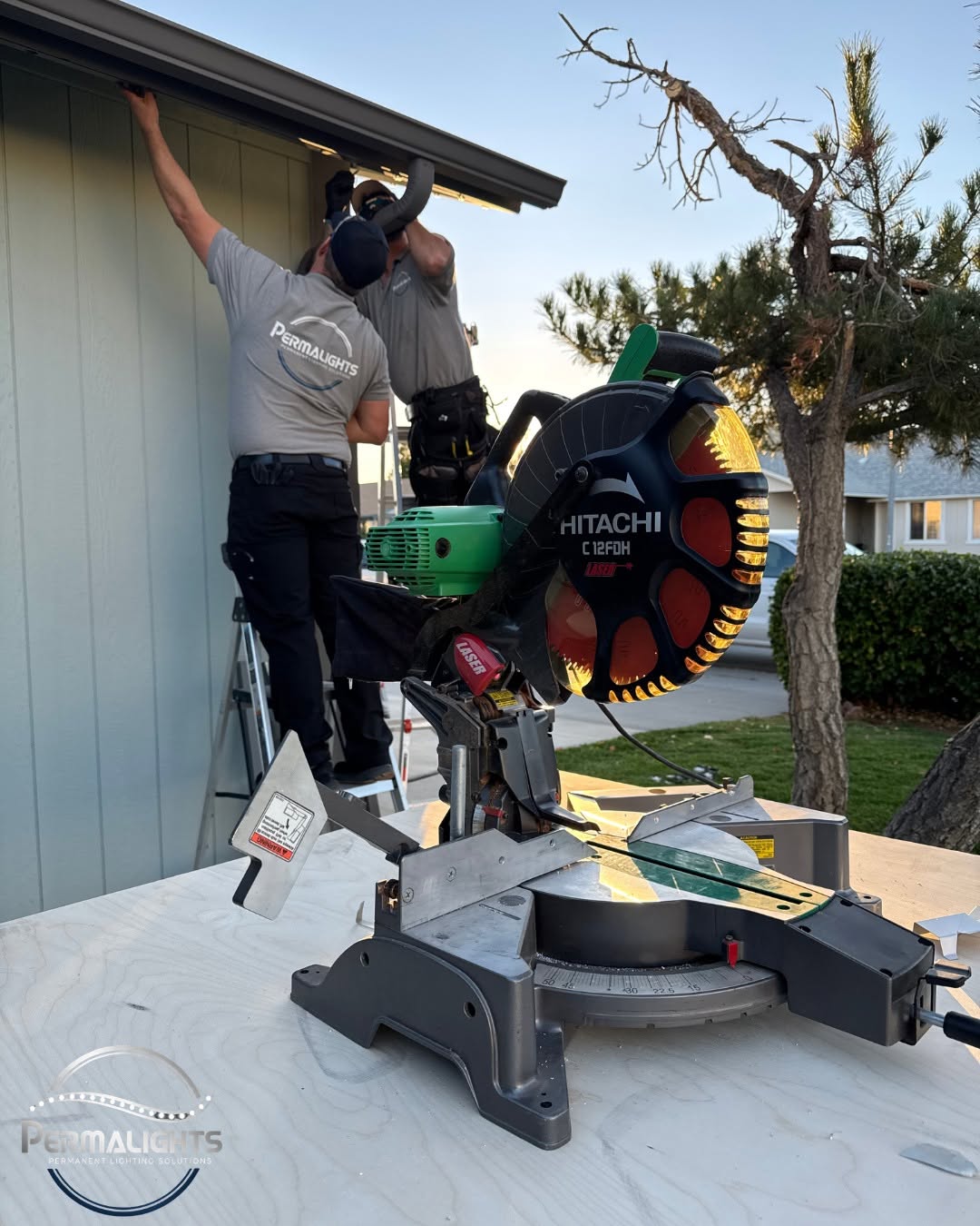 Installer mounting hidden lighting track on a fascia